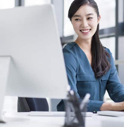 Woman smiling at desktop